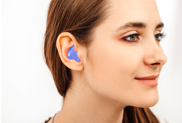 A young lady wearing custom hearing protection